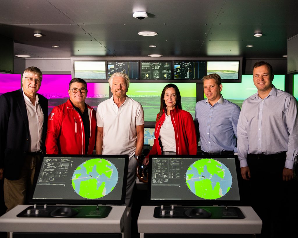 group of people standing in simulator