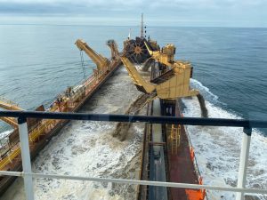 image of an aggregate hopper dredging agreggates onto a ship